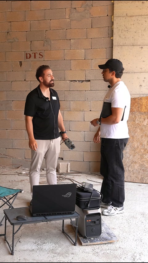 Şantiye içinde iki kişi, tarama ekipmanıyla keşif hazırlığı yapıyor.