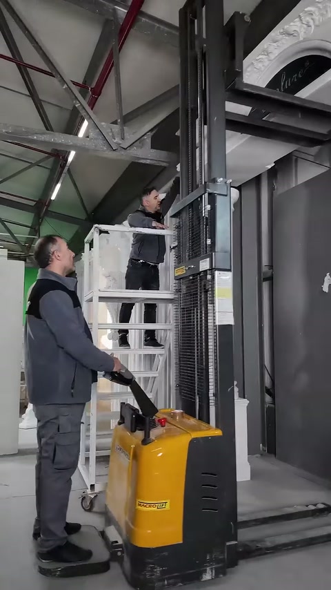 Operatör, kaldırma aracından merdivendeki ustanın çalışmasını takip ediyor.
