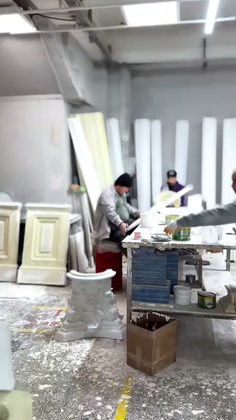 Öndeki usta masa üzerindeki beyaz parçaya işlem uyguluyor.