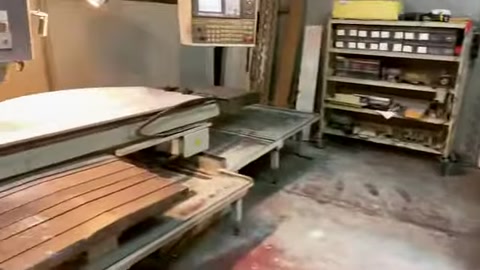 CNC tezgahında işlenecek büyük beyaz model parçası konumlandırılmış