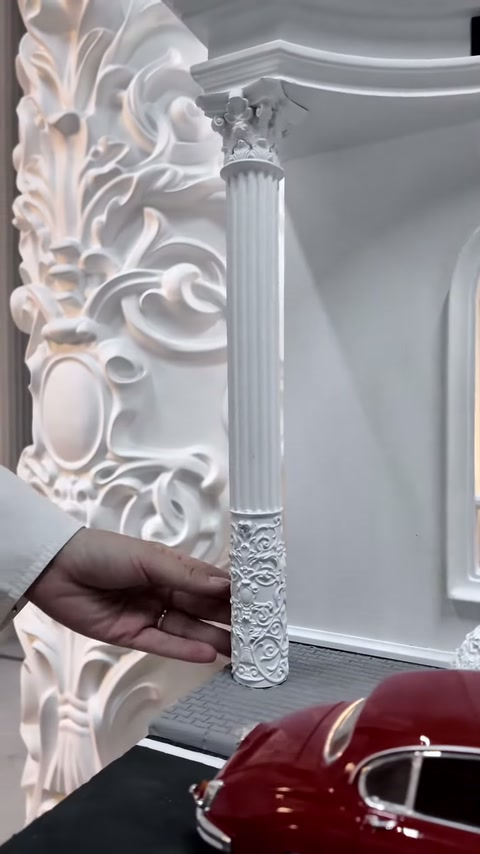 Küçük sütun maketi büyük kabartmalı gövde önünde yakından sunuluyor.