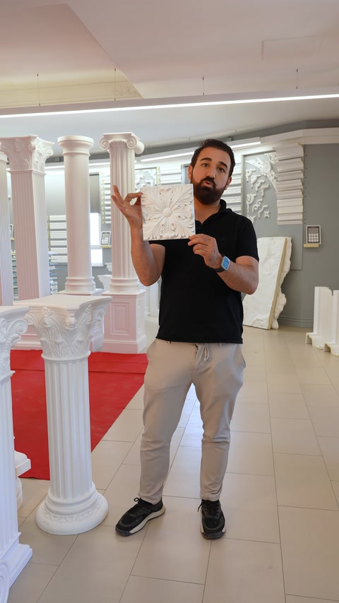 Showroomda standart dekoratif rölyef parçası sütunlar önünde tanıtılıyor