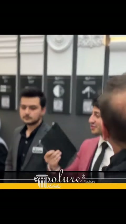 Görevliler, duvara monte söve ve süsleme örnekleri önünde konuşuyor