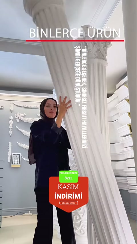 Kabartmalı başlıkları bulunan uzun beyaz sütunlar sergi alanında gösteriliyor