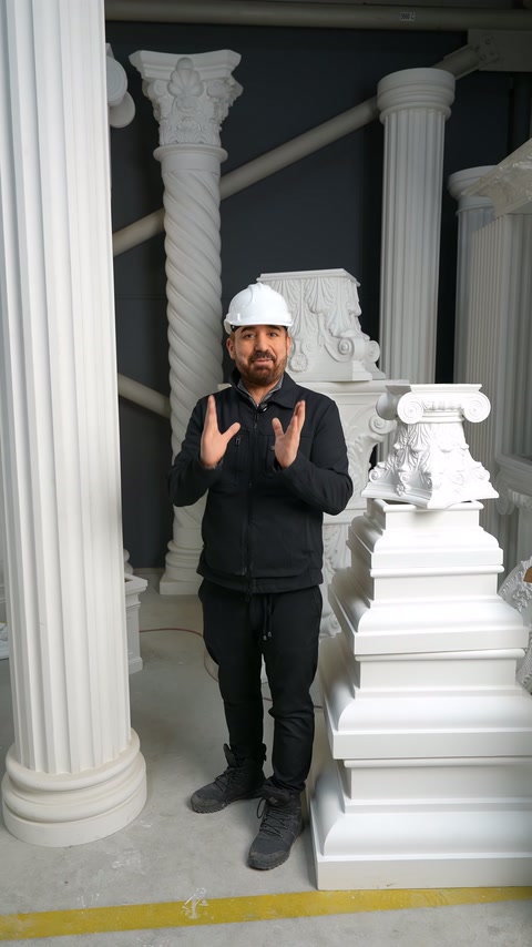 Atölyedeki sütun koleksiyonu önünde sunucu anlatımını iki eliyle sürdürüyor.