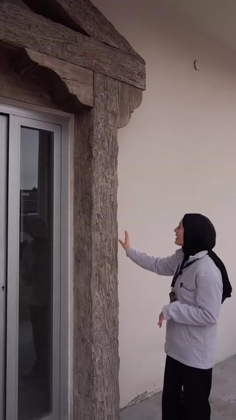 Dış cephede pencere yanında uygulanan dikey ahşap görünümlü kiriş